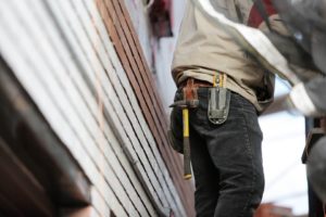 Construction worker wearing a tool belt at a building site